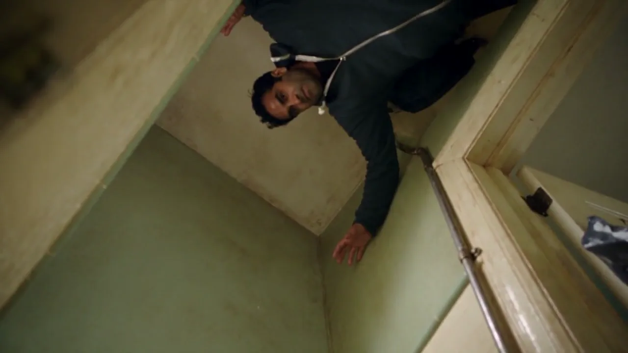 Person clinging to the bathroom ceiling