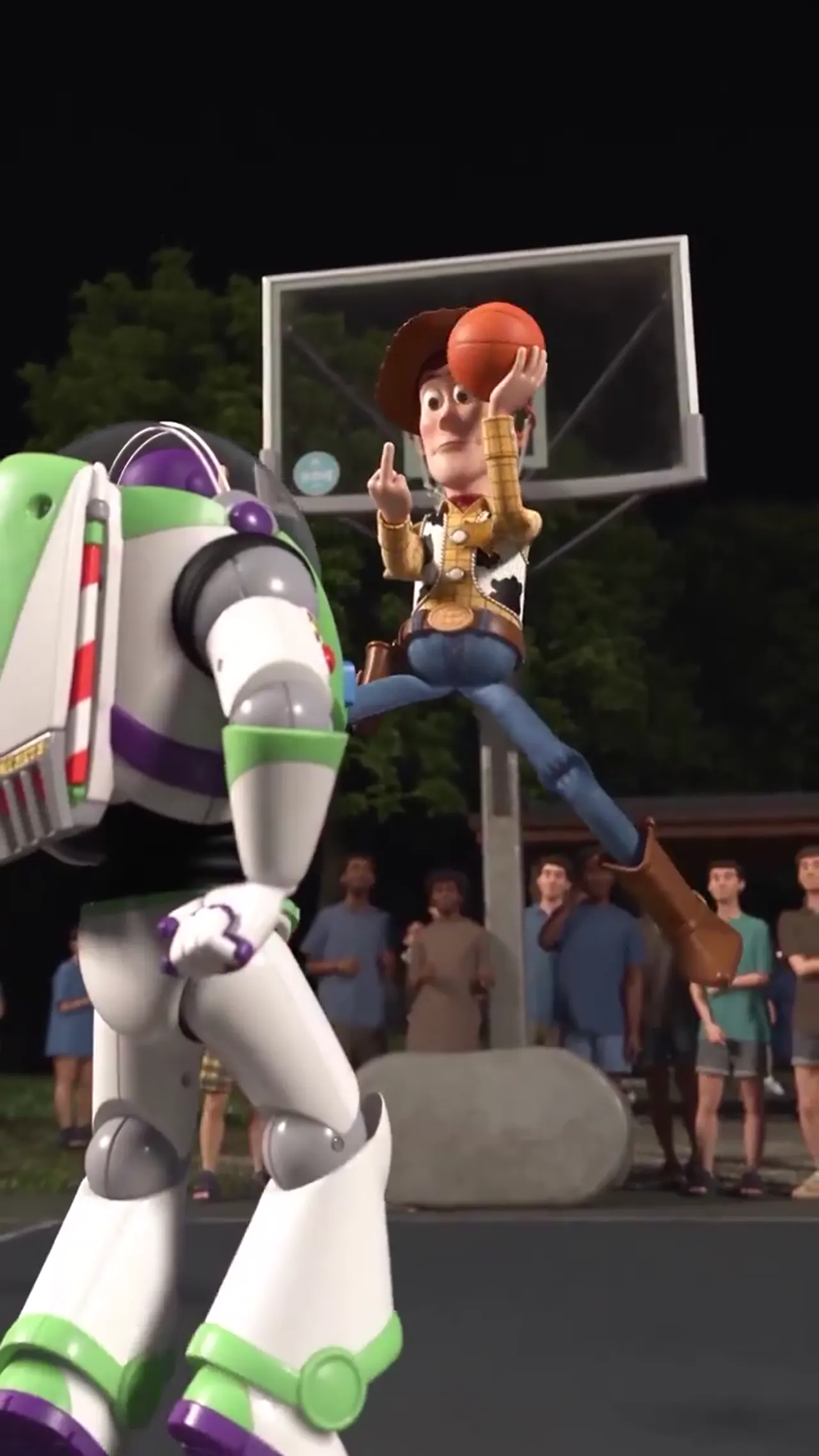 Woody holds the ball at the rim above Buzz