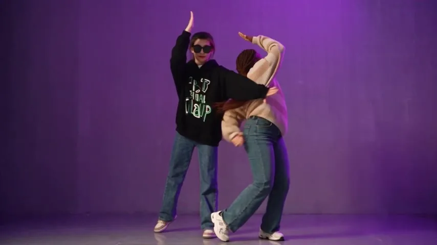 Diagonal arms: one dancer faces away